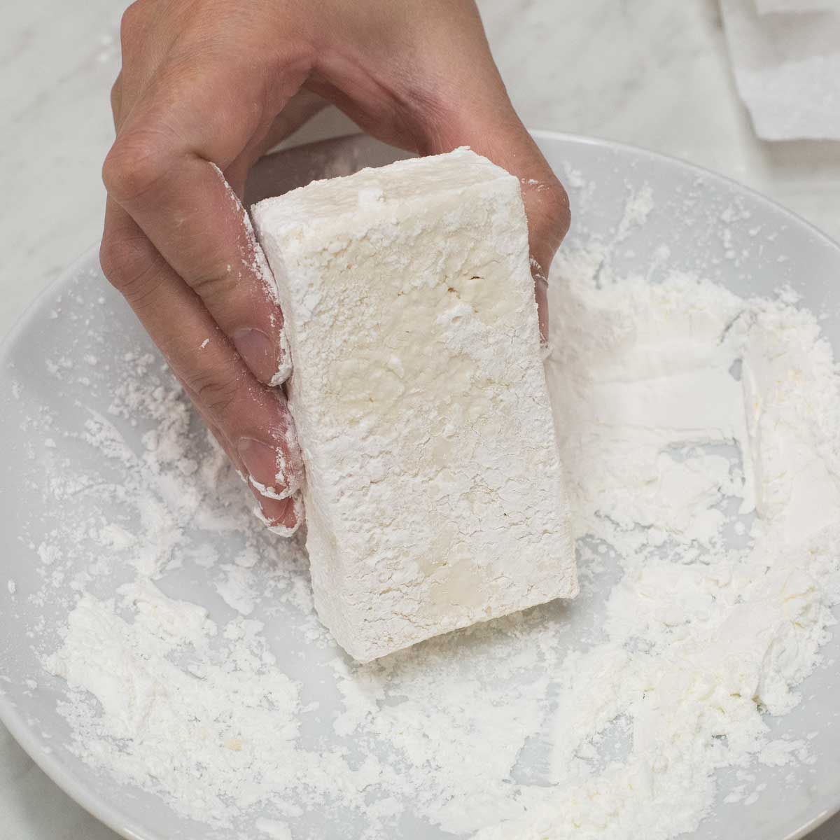 coating the tofu with starch.
