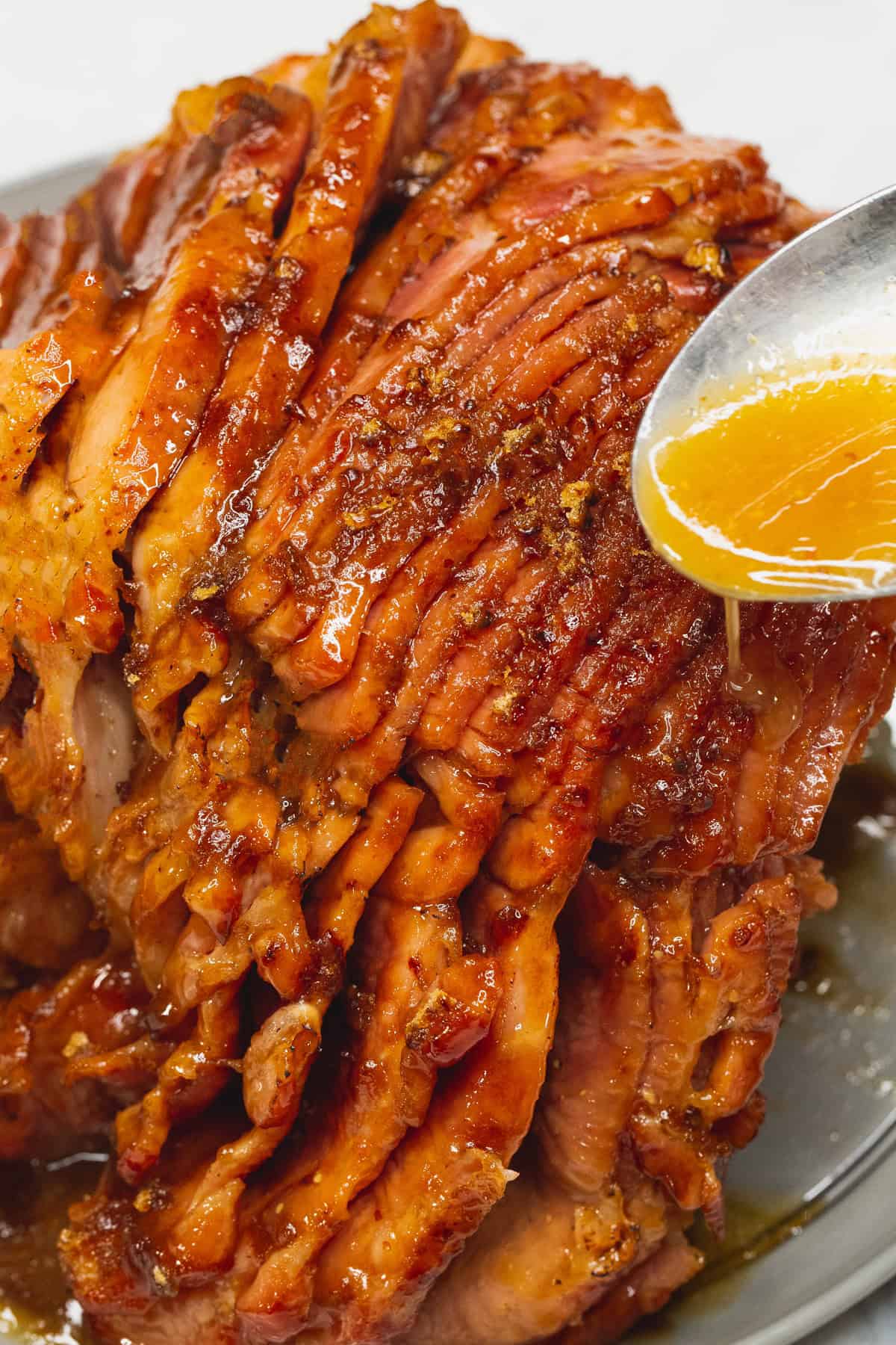 Pouring the sauce over the brown sugar-crusted ham.