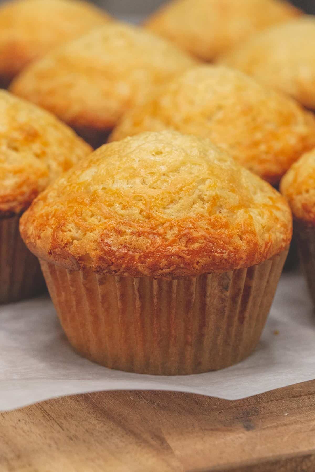 Cheese Cupcakes on a parchment paper-lined cutting board.
