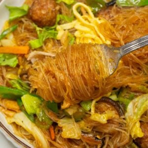 Sotanghon Guisado rolled by a fork.