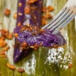 Ube Suman sa Latik picked by a fork.