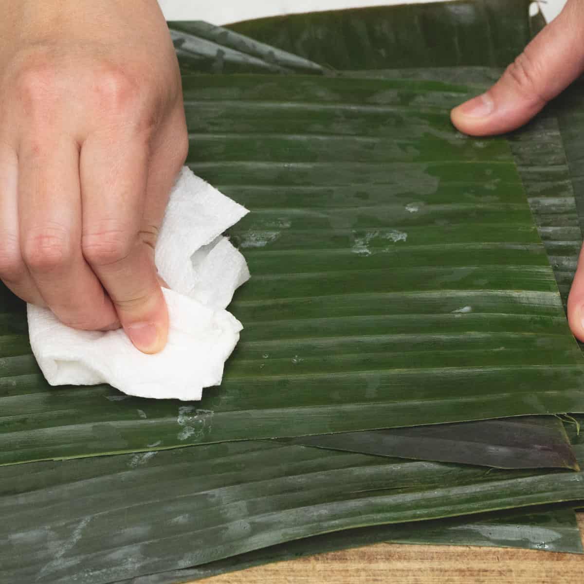 Wiping the banana leaves