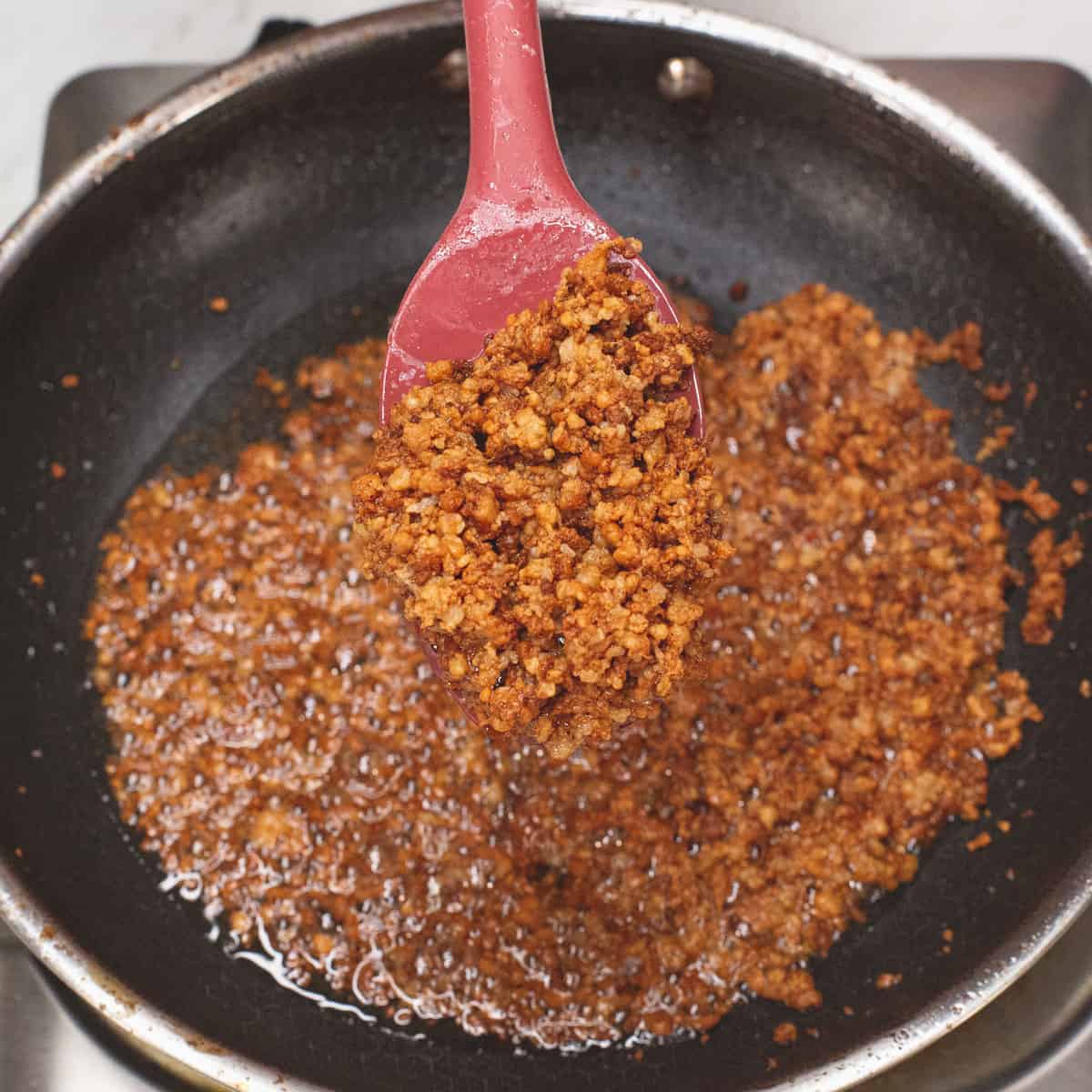 Making the latik on a skillet.