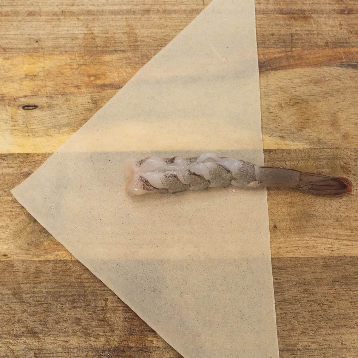 placing shrimp in the center of the wrapper
