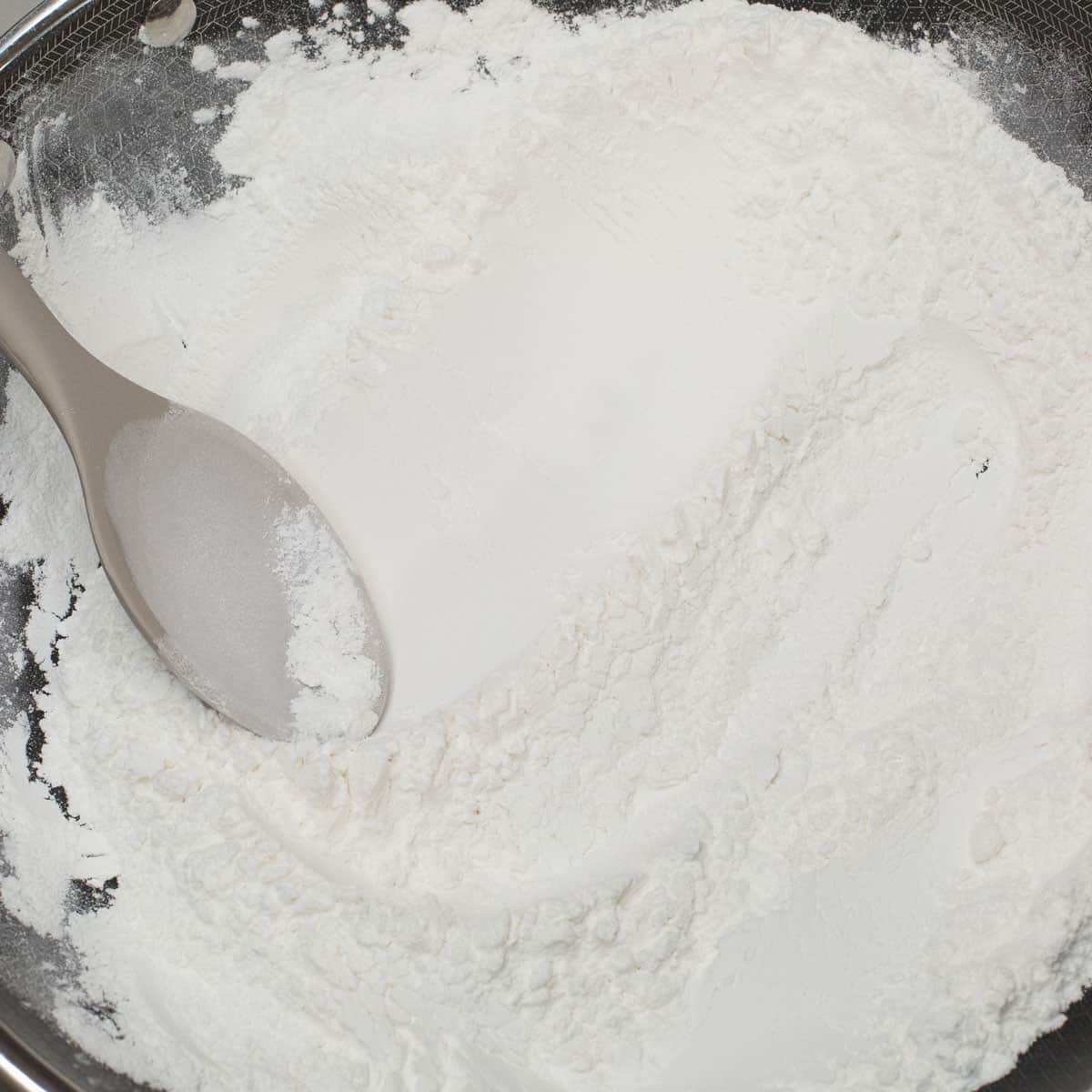 Toasting the glutinous rice flour in a wok.