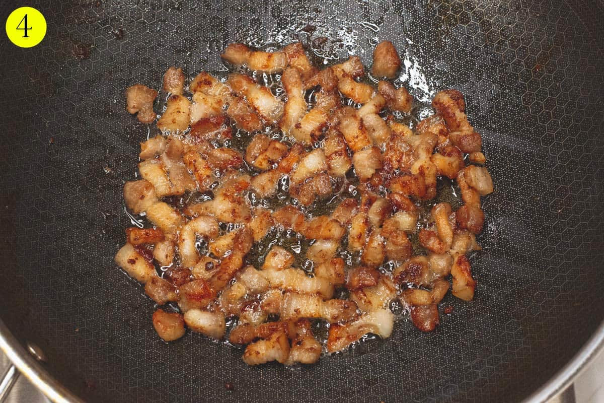 Browning the pork in a wok.