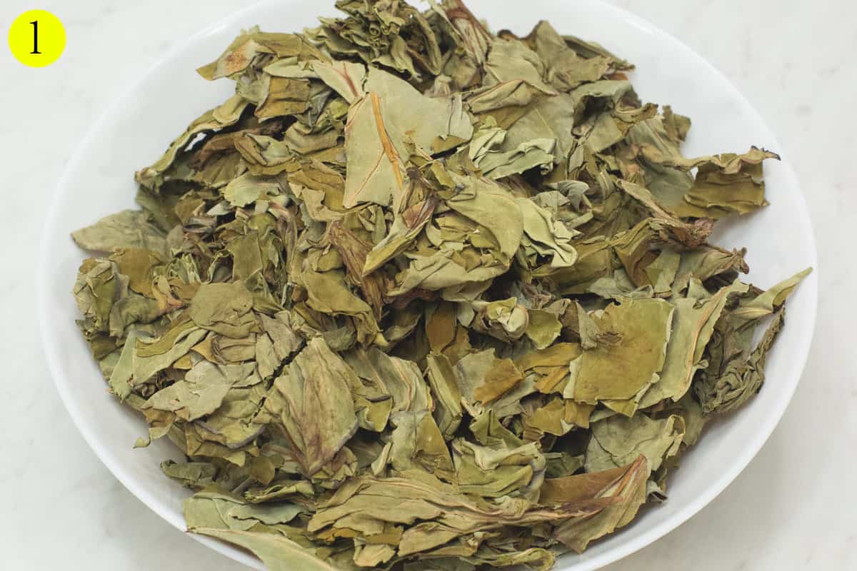 Dried taro leaves in a bowl.