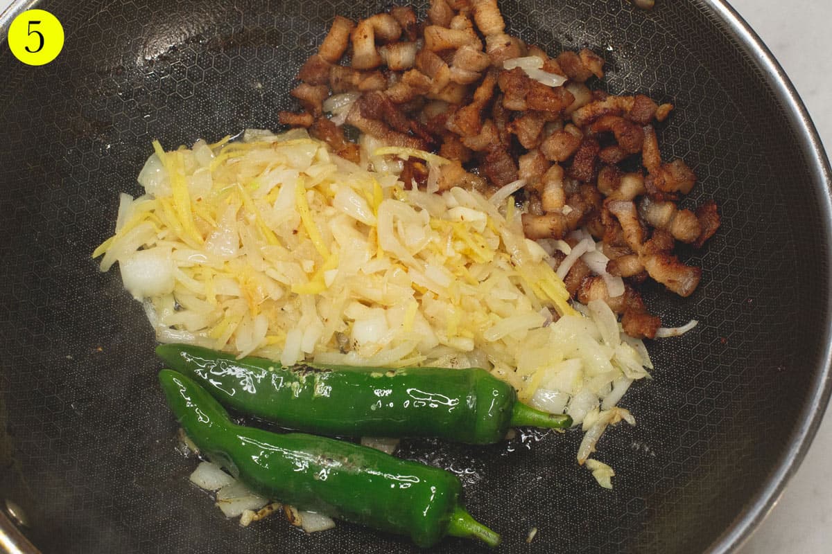 Sauteing the aromatics and chilies in the wok.