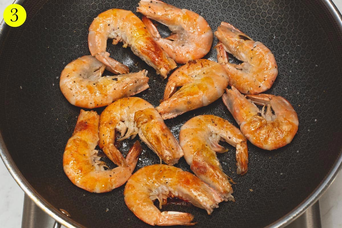 Searing the shrimp in a wok.