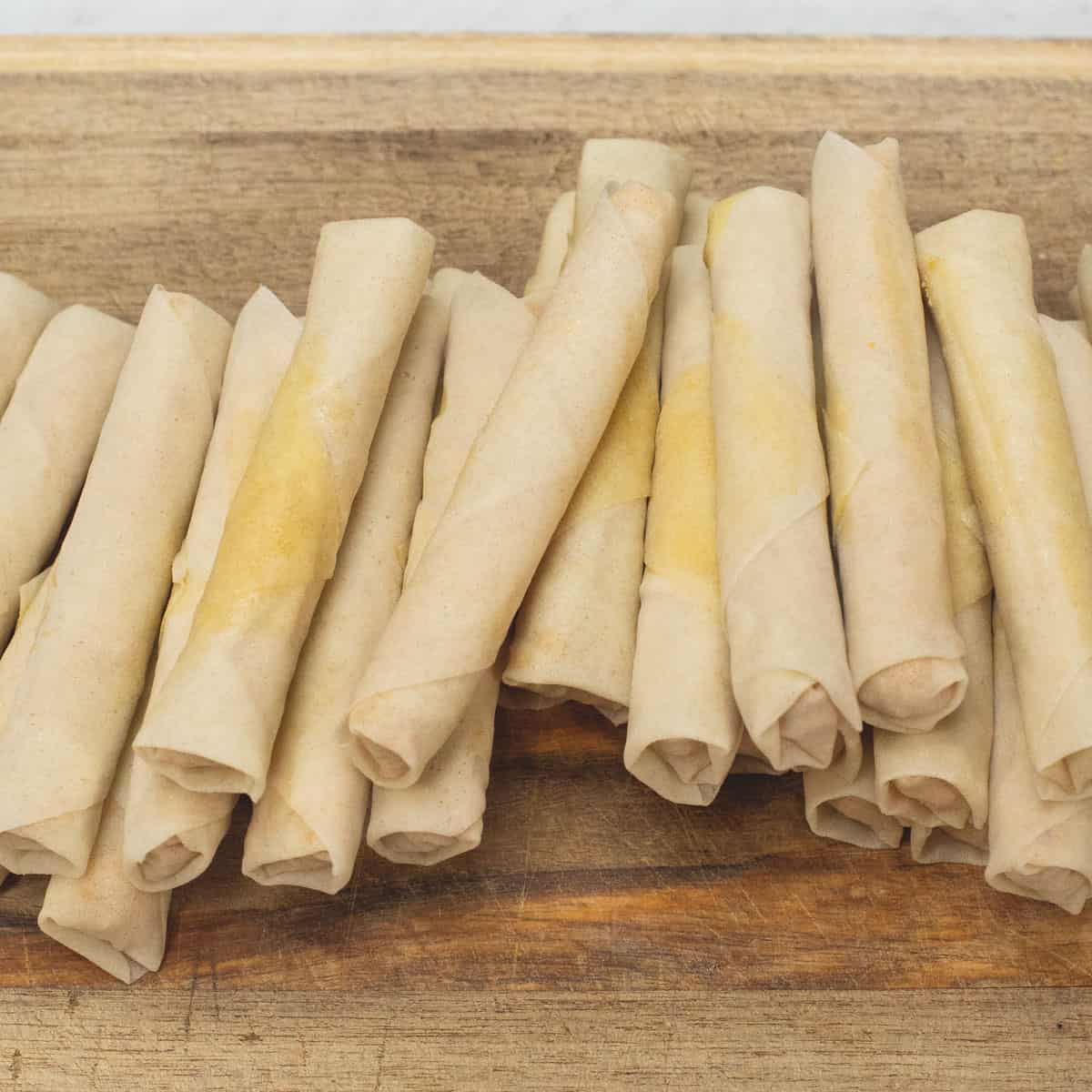 Wrapped Turones de Mani on a cutting board.