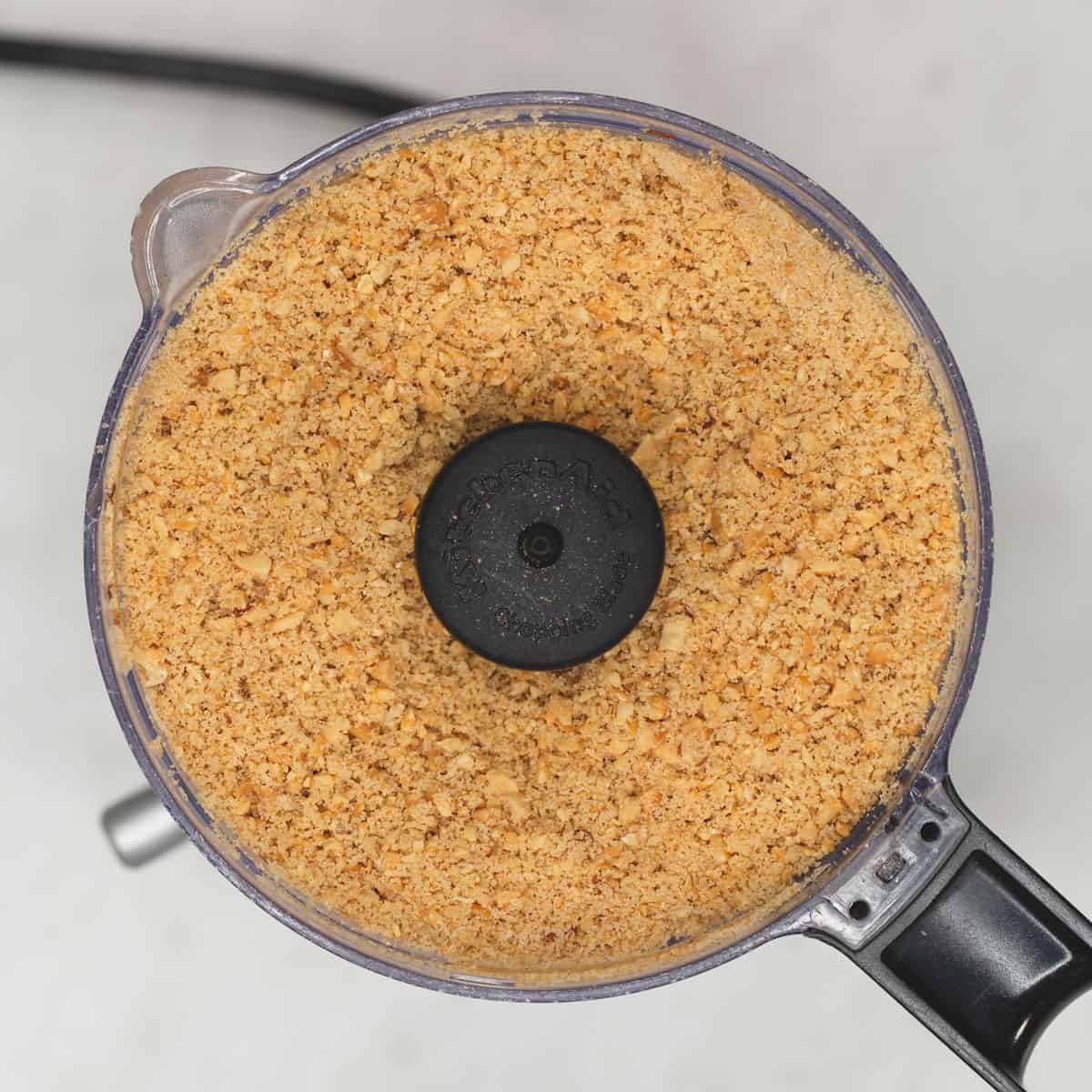 Grinding the nuts with brown sugar in a food processor.