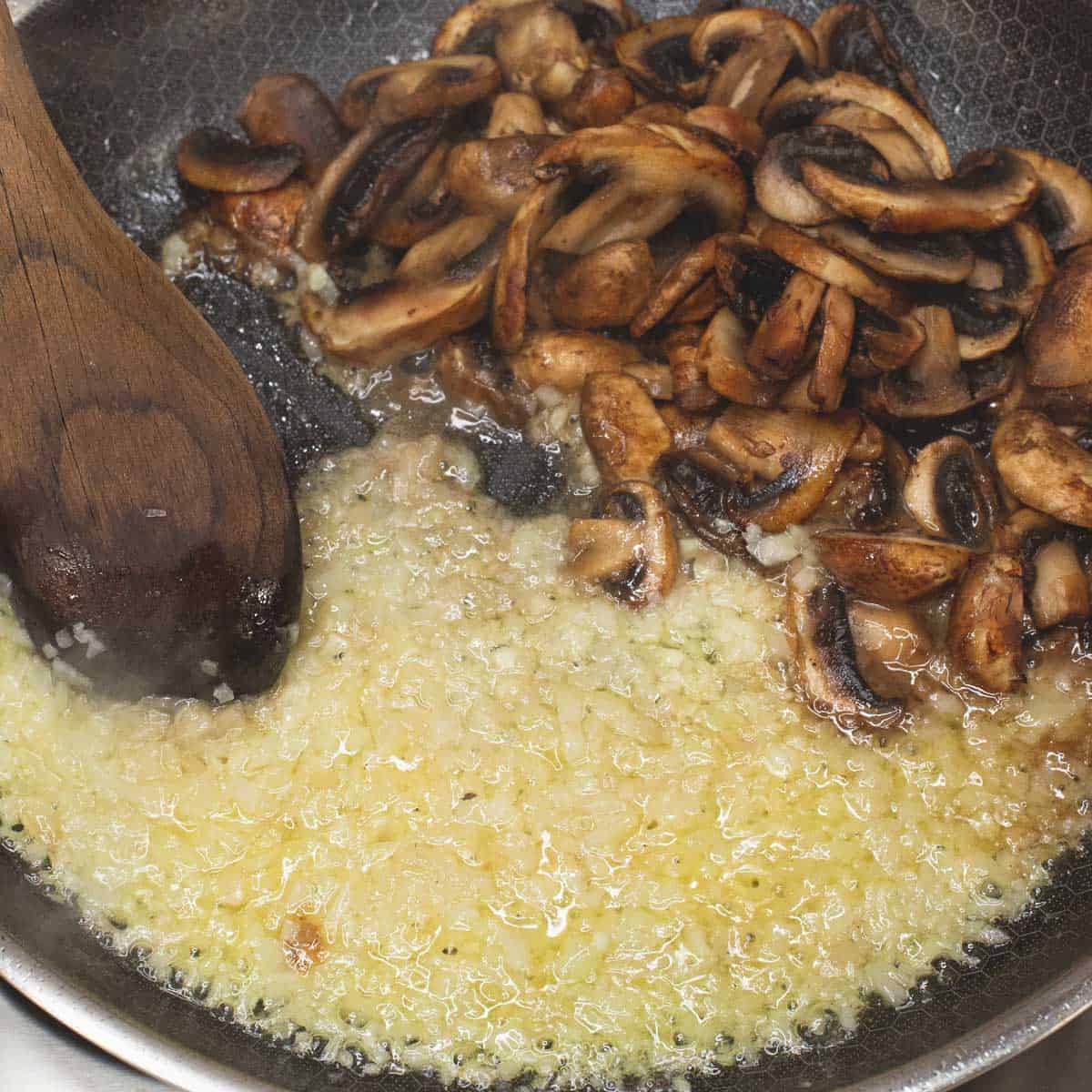 Sauteing the aromatics in a skillet.