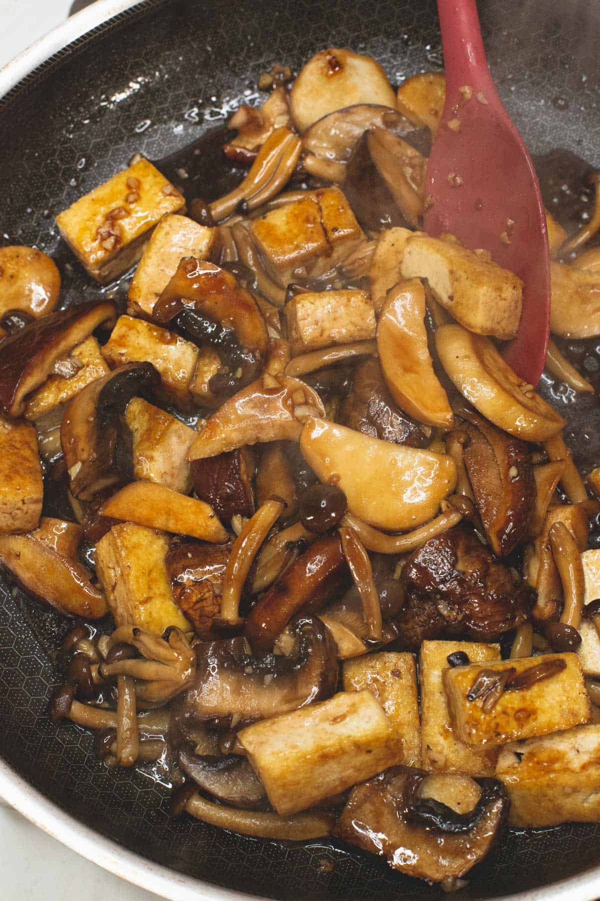 Cooked Tofu and Adobo Mushrooms in a skillet.