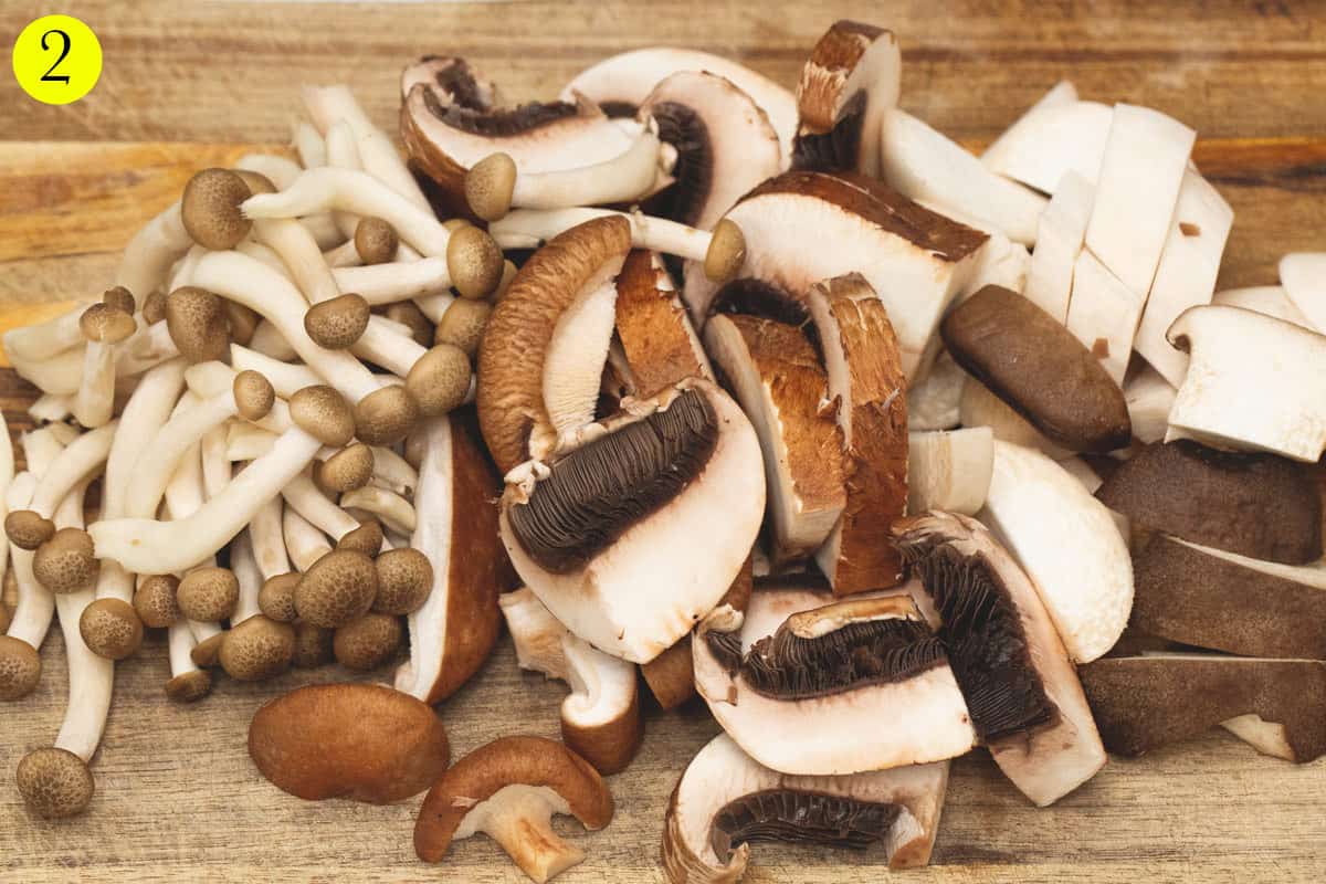 Cut up mushrooms on a cutting board.