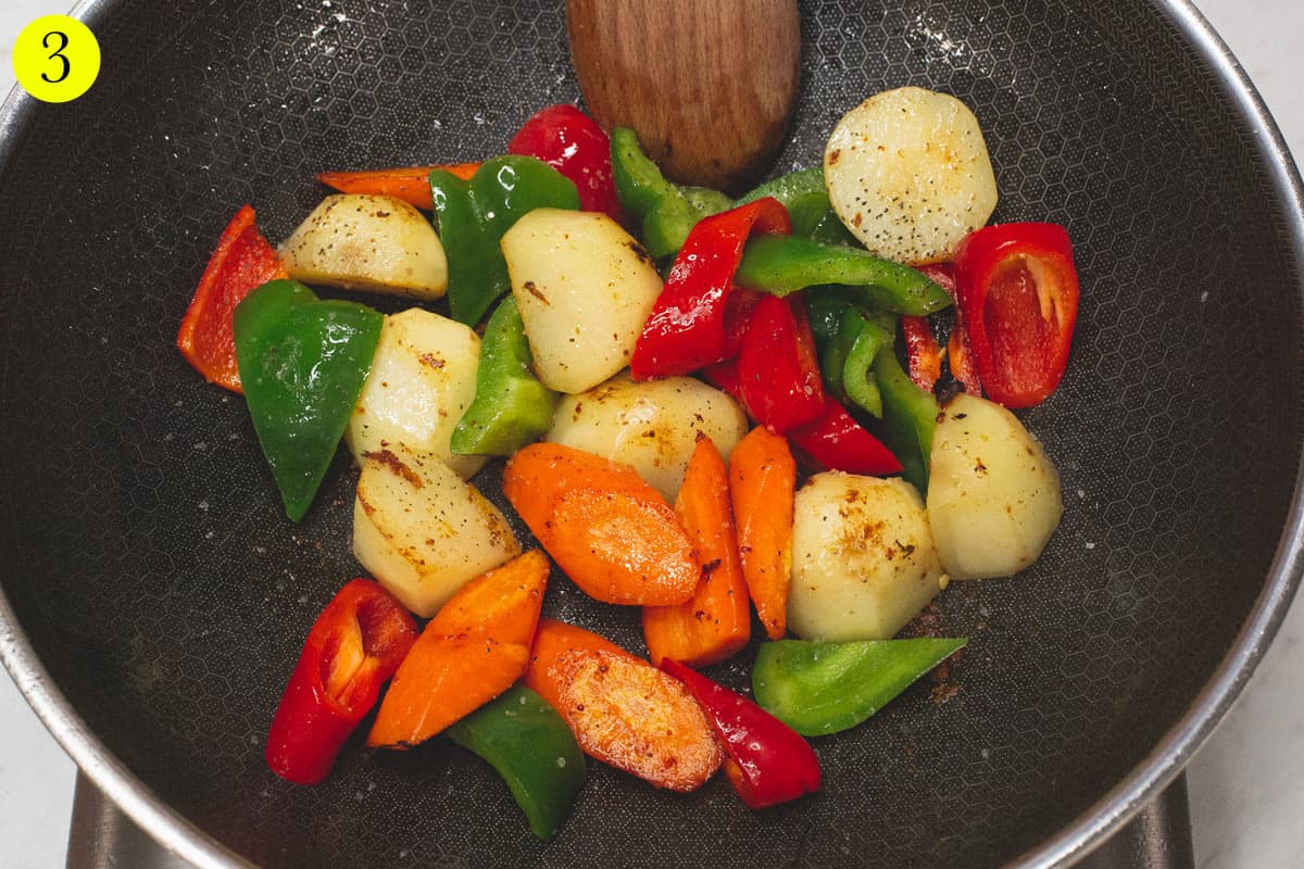 Searing the vegetables in the wok.