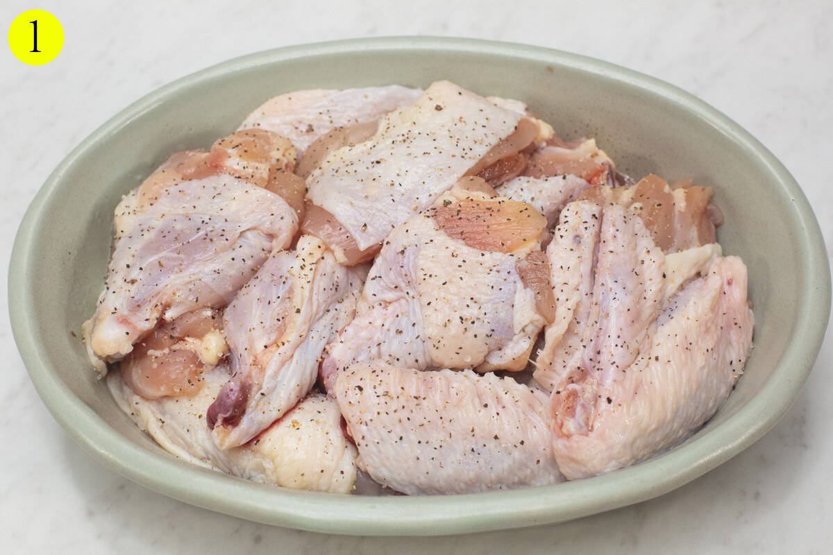 Seasoned pieces of chicken on a platter.