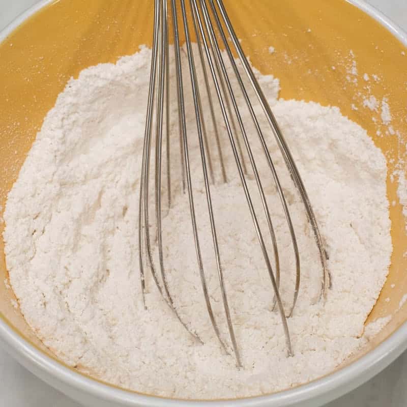Whisking the dry ingredients in a bowl.