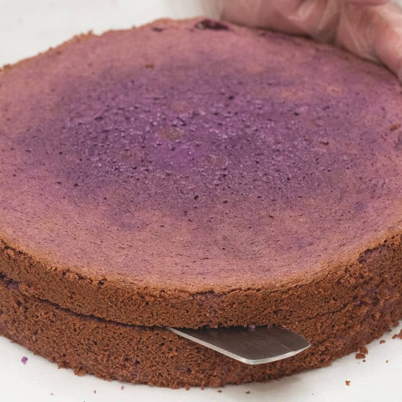 Cutting the cake horizontally into two equal parts.