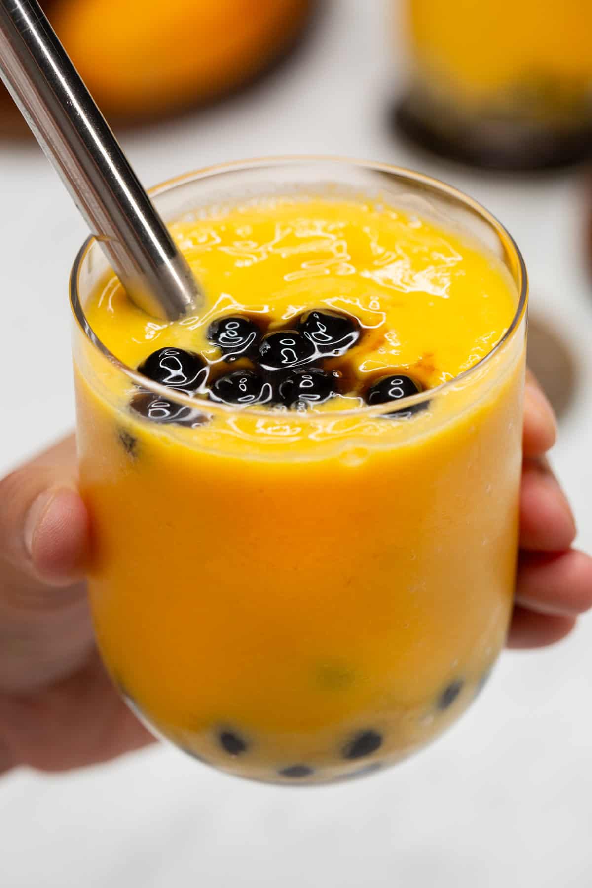 Mango shake with boba in a glass