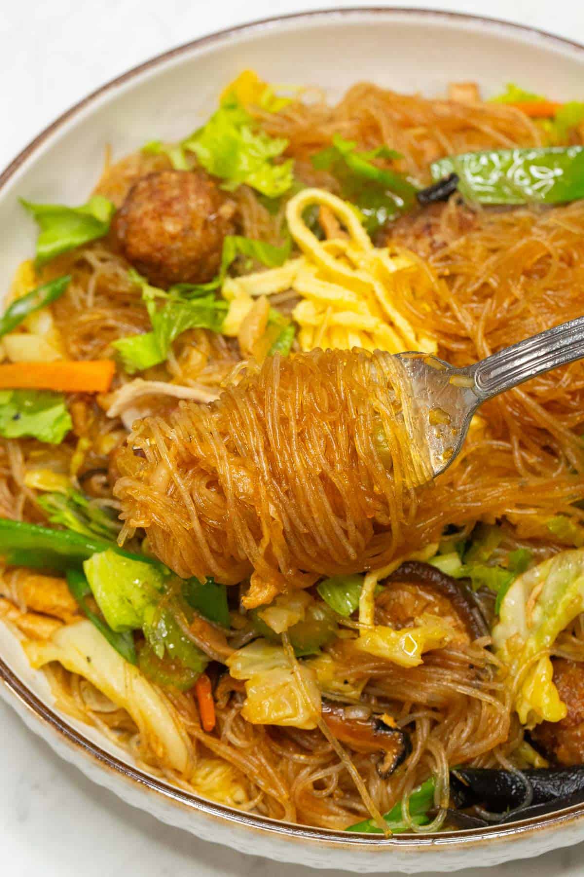 Sotanghon Guisado on a fork.