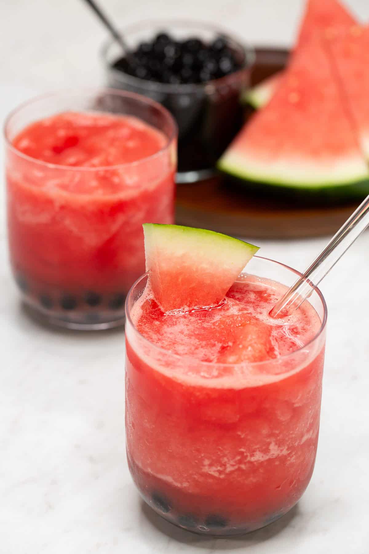 Watermelon Slushie with Boba in glasses with a straw.