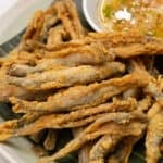 Crispy fried Smelt on a plate with sauce