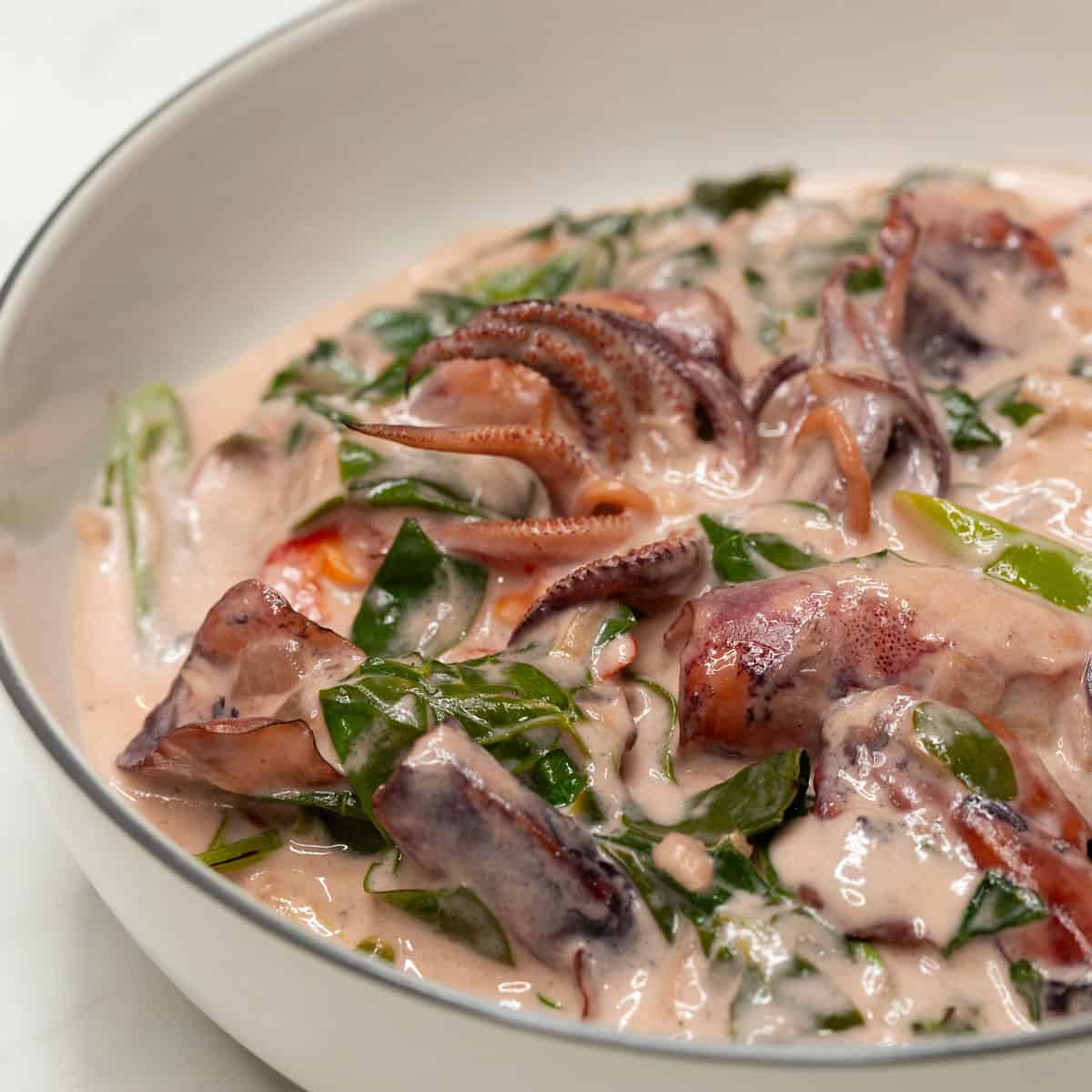 Ginataang Pusit with Malunggay in a bowl.