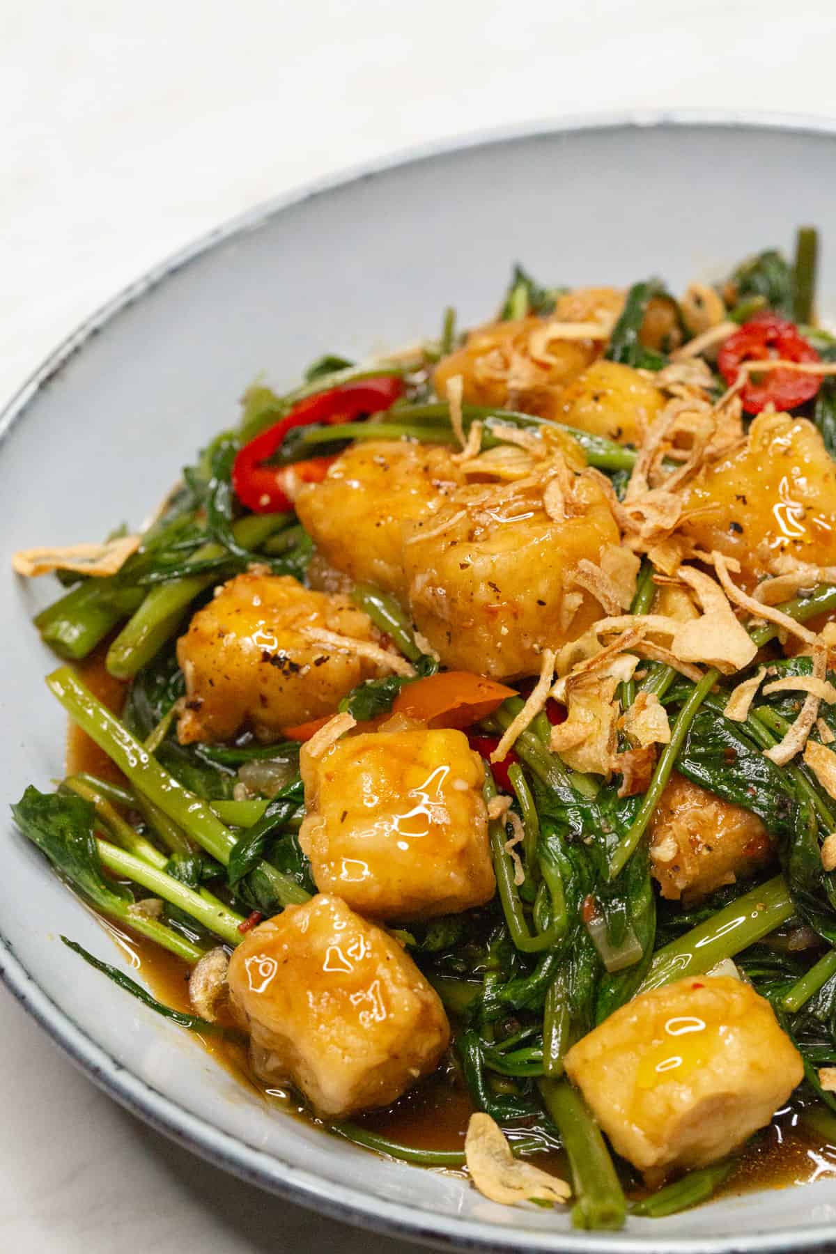 Stir-fried Kangkong and Tofu in a bowl.