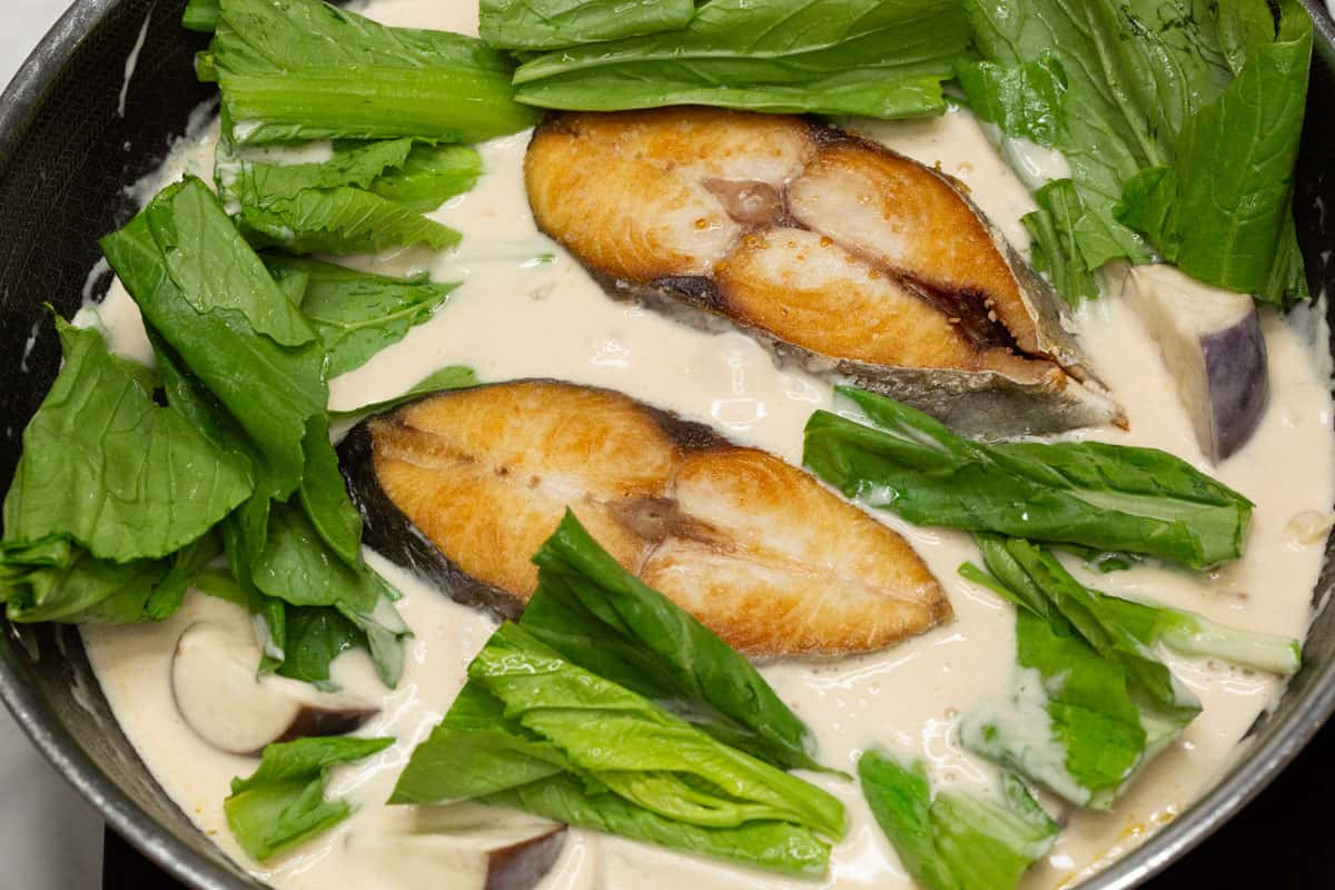 adding watercress into the mixture.