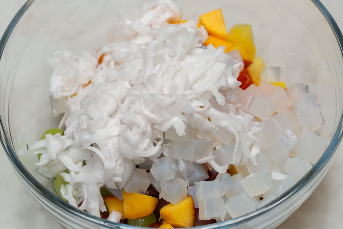 Fresh fruits, buko, and nata de coco in a bowl.