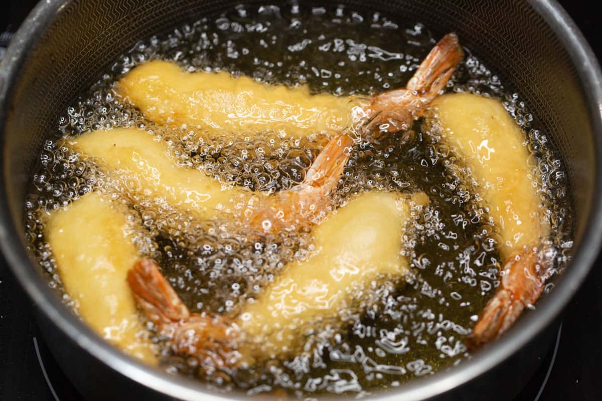 Frying the shrimp in a small saucepan.