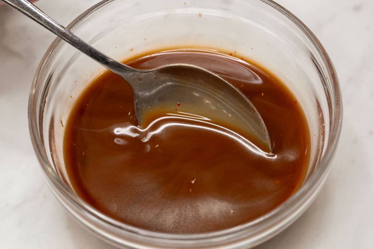 Mixing the sauce in a bowl.
