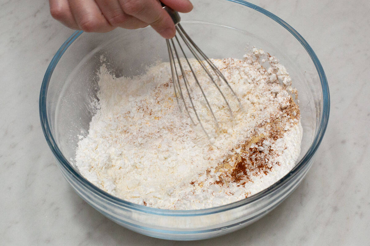 Mixing the dry coating in a bowl using a whisk.