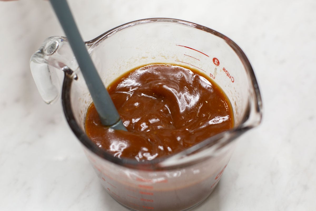 Mixing the sauce in a measuring cup.