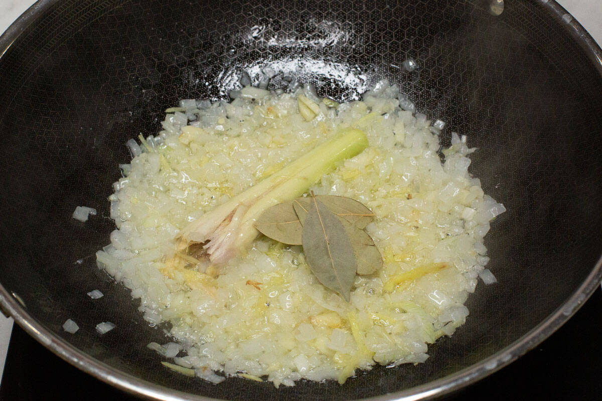 Sauteed aromatics in a wok.