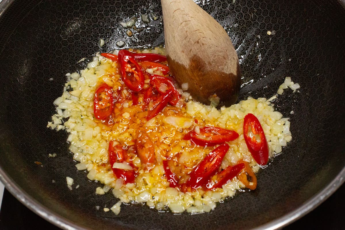 Sauteing the aromatics in a wok.