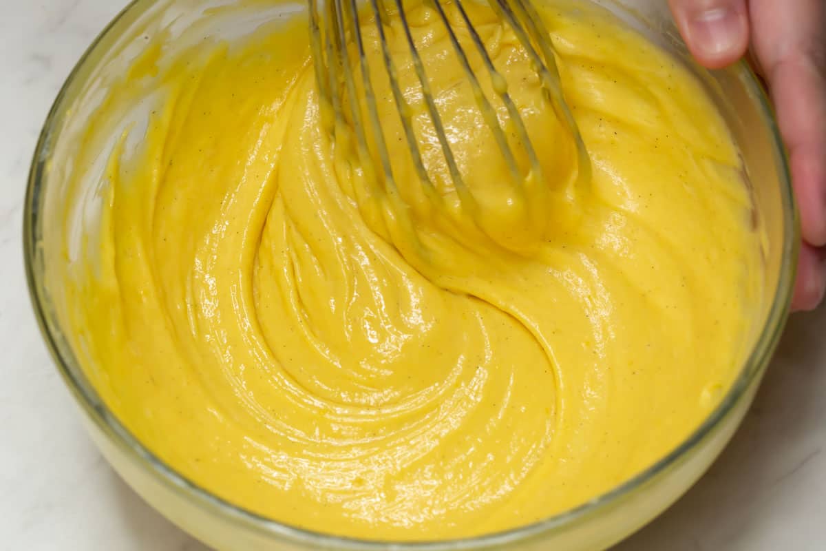 Mixing the custard filling with a whisk.