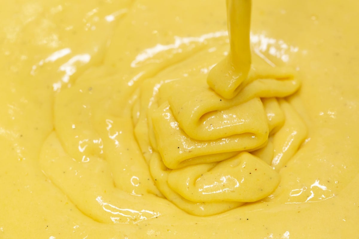 Custard falling in a thick ribbon.