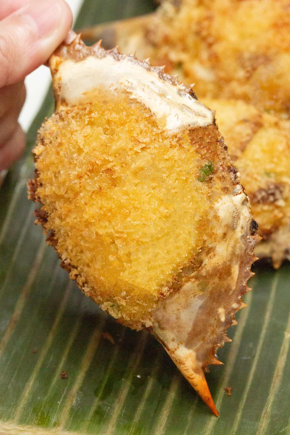Holding a piece of Crab Relleno (Relyenong Alimasag).