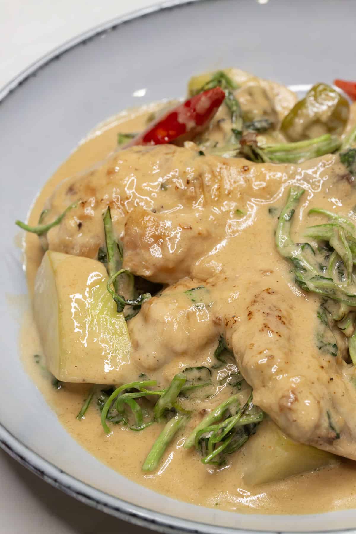 Ginataang Manok with Green Papaya and Watercress in a bowl.