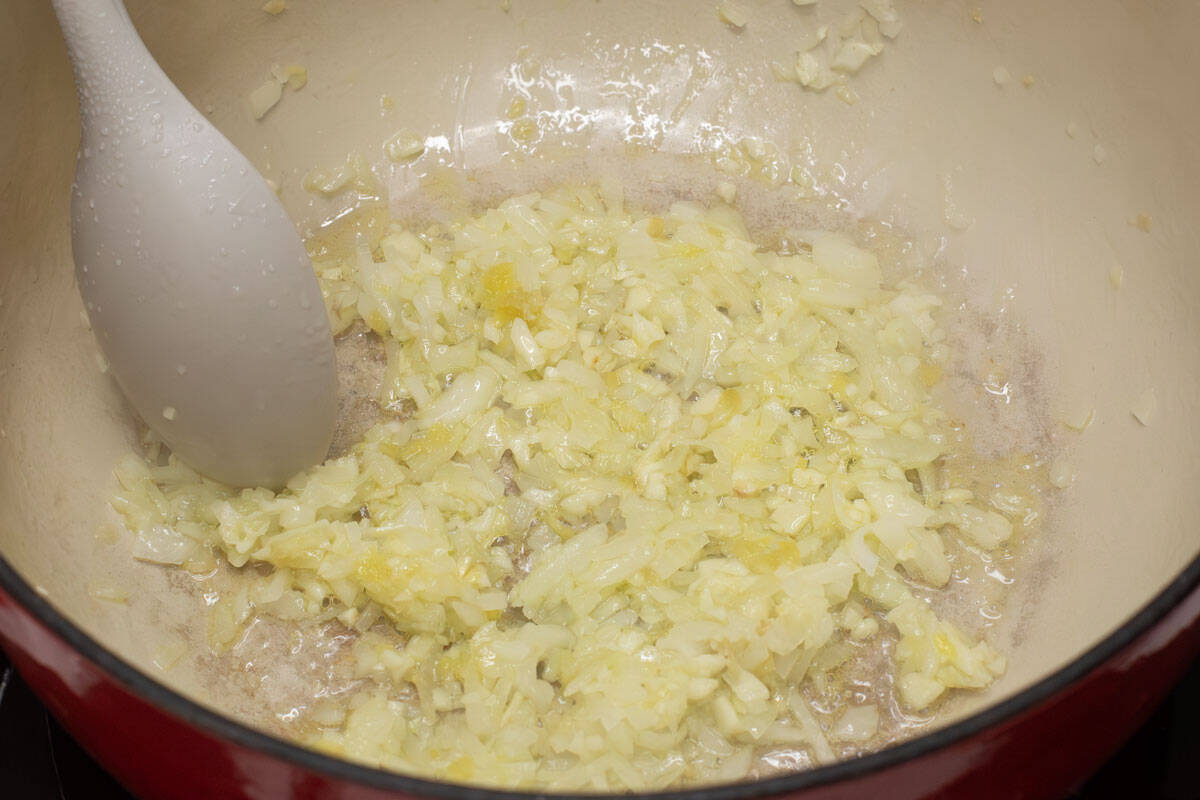 Sauteing aromatics in a pot.