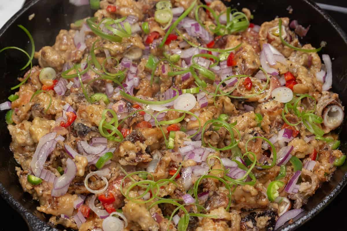 Crispy Squid Sisig in a skillet.