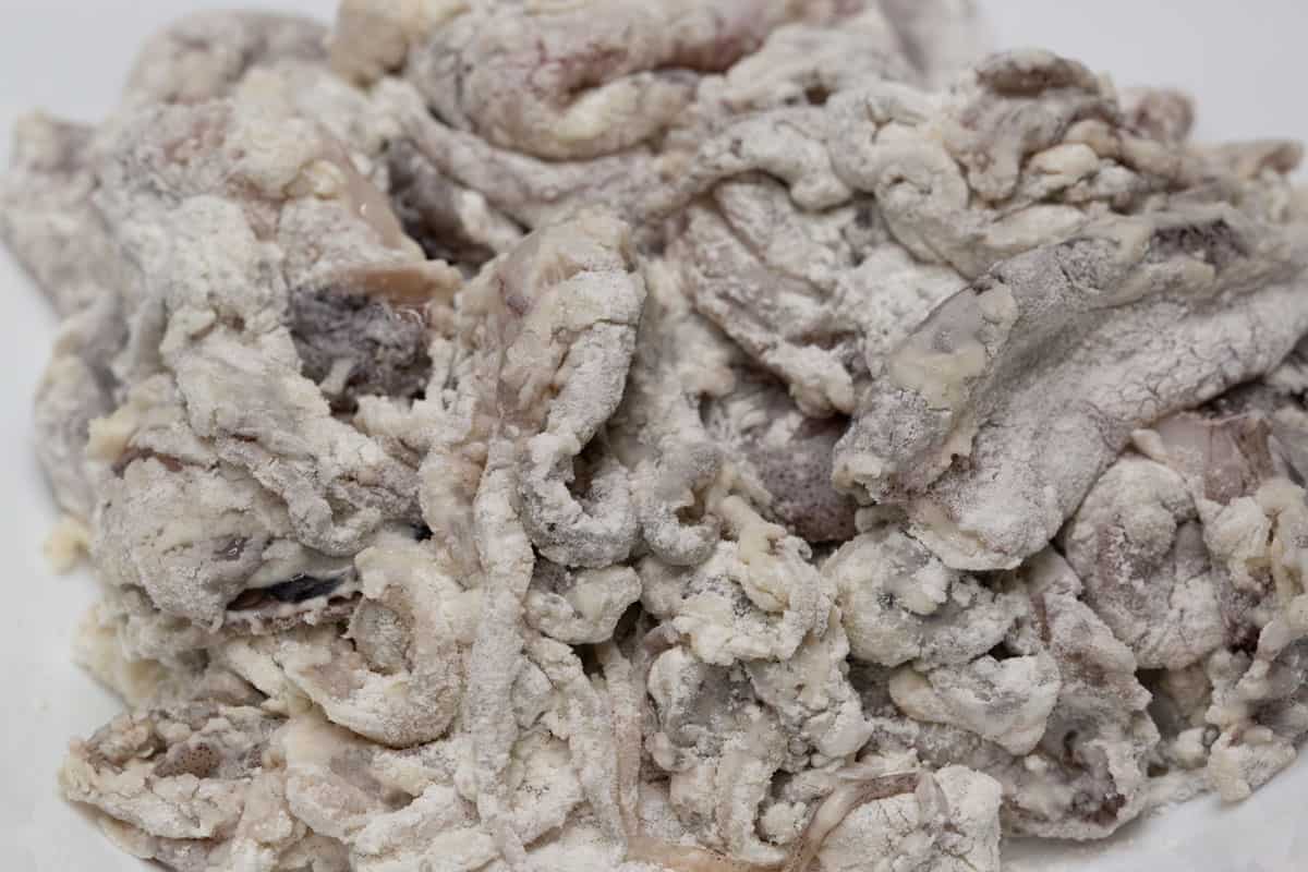 Coated pieces of squid on a plate.