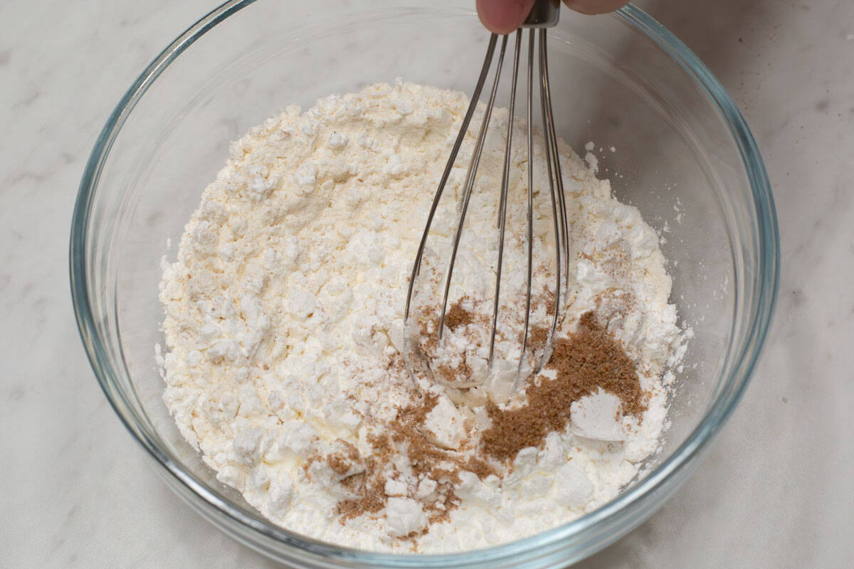 Whisking the dry coating in a bowl.