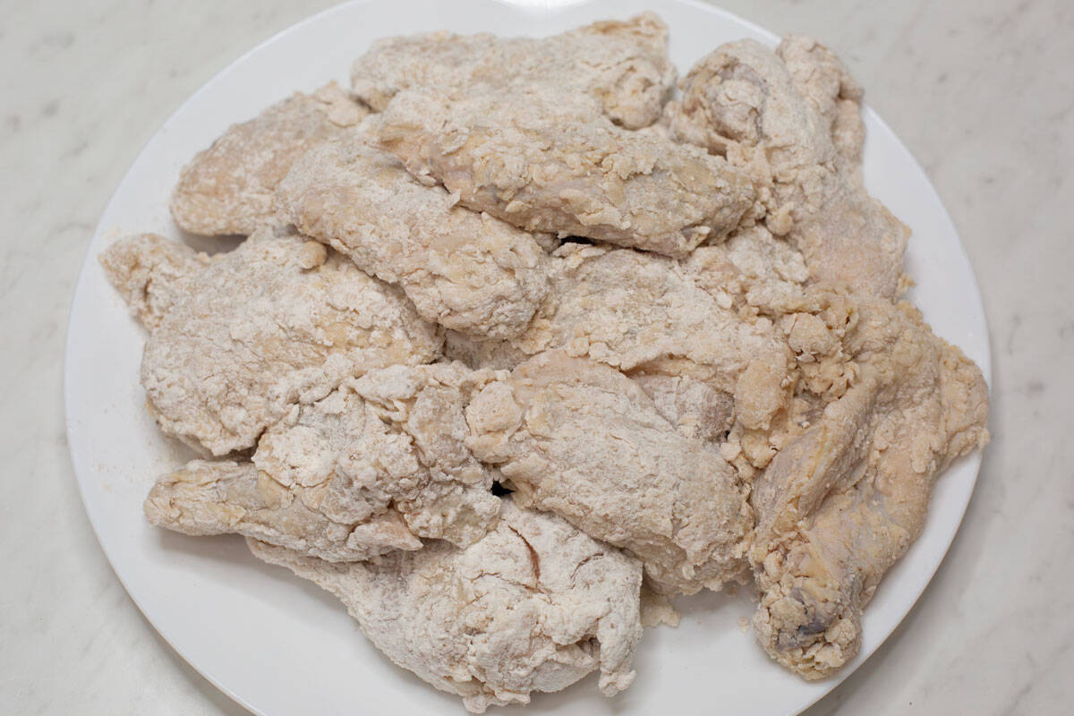 Coated chicken pieces on a plate.