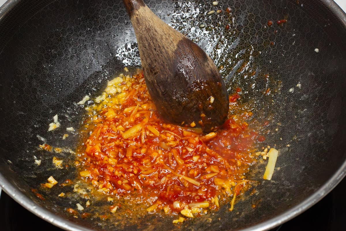 Sauteing the aromatics in a wok.
