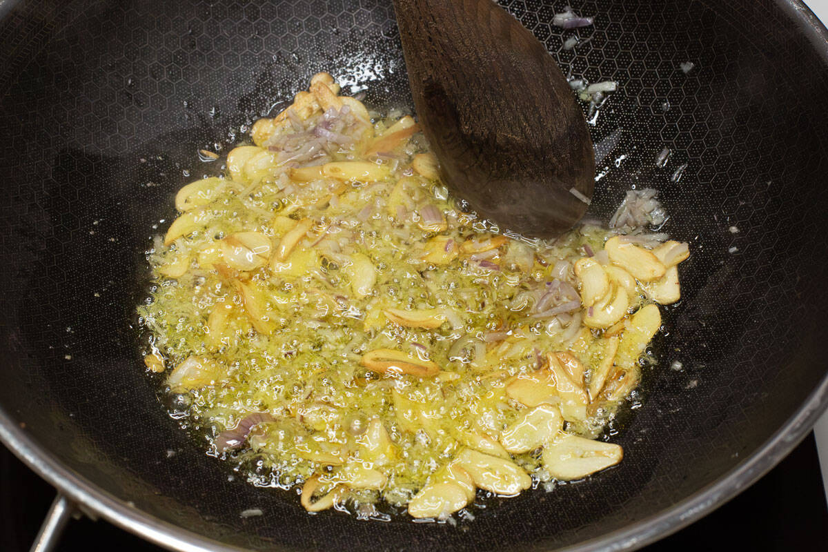 Sauteing the garlic and shallot in olive oil.
