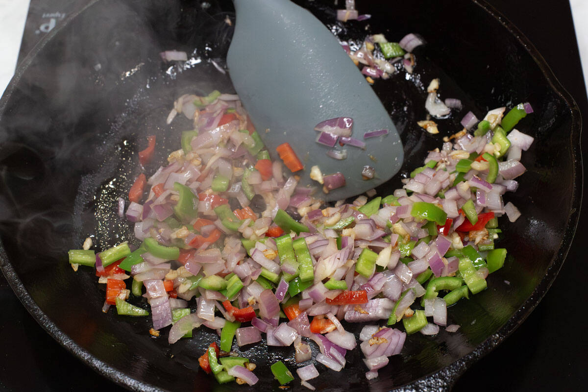 Sauteing the aromatics in a skillet.