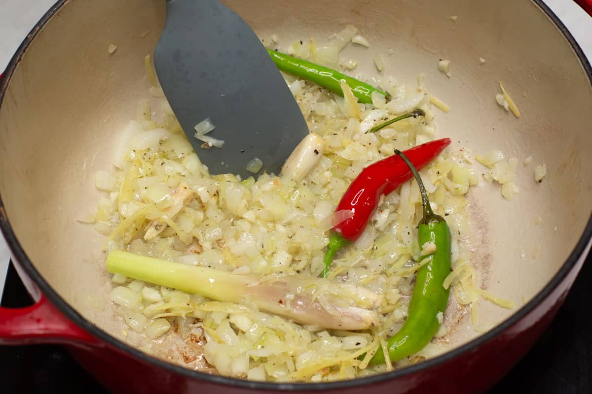 Sauteing the aromatics in a pot.