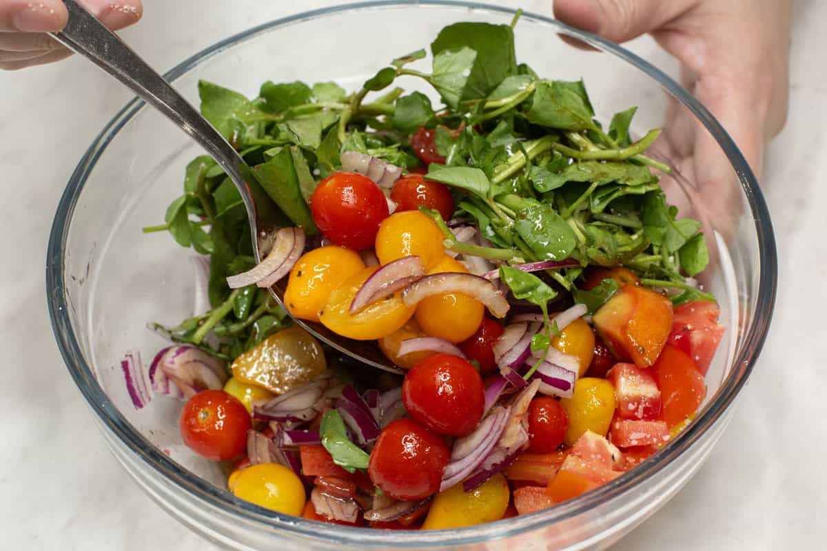 Mixing the salad in a bowl